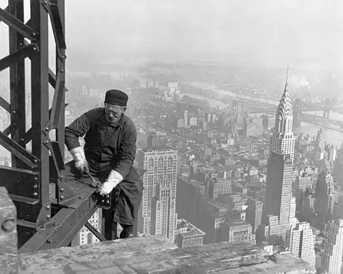 Image 3Empire State BuildingImage credit: Lewis HineA structural worker bolts beams on the framework during the construction of the Empire State Building in New York City. The 1,250-foot (380 m) building opened on May 1, 1931, at the time the tallest building in the world, overtaking the Chrysler Building (seen to the right), which had just been completed the year before. The addition of a pinnacle and antennas later increased its overall height to 1,472 feet (449 m).More selected pictures
